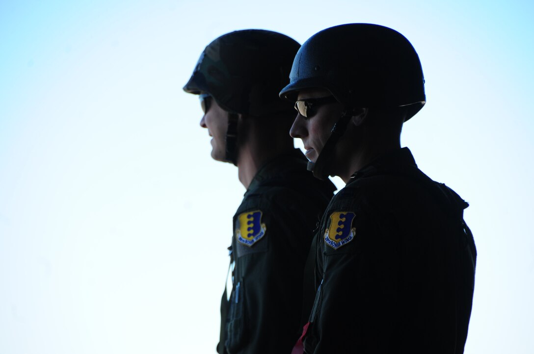 ELLSWORTH AIR FORCE BASE, S.D. - (Left to right) 1st Lt. Chris Madson, 37th Bomb Squadron weapons systems officer and Capt. Curtis Michael, 37 BS pilot, wait for transport after processing through into the play area during a Phase II Operational Readiness Inspection, Oct. 15.  During the Phase II ORI Airmen, enlisted and officer, are tested on their abilities to operate in a simulated-deployed area. (U.S. Air Force photo/Airman 1st Class Anthony Sanchelli) 
