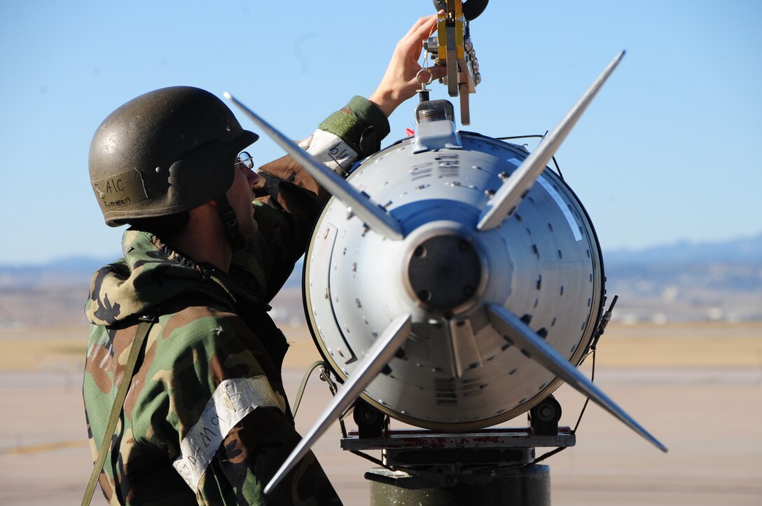 ELLSWORTH AIR FORCE BASE, S.D. - Airman 1st Class Timothy Foreman, 28th Munitions Squadron munitions load crew member, attaches an inert guided bomb unit-31 onto a bomb lift during a Phase II Operational Readiness Inspection, Oct. 15.  Munitions Airmen are crucial to getting the wings mission of "bombs on target" completed. (U.S. Air Force photo/Airman 1st Class Anthony Sanchelli).
