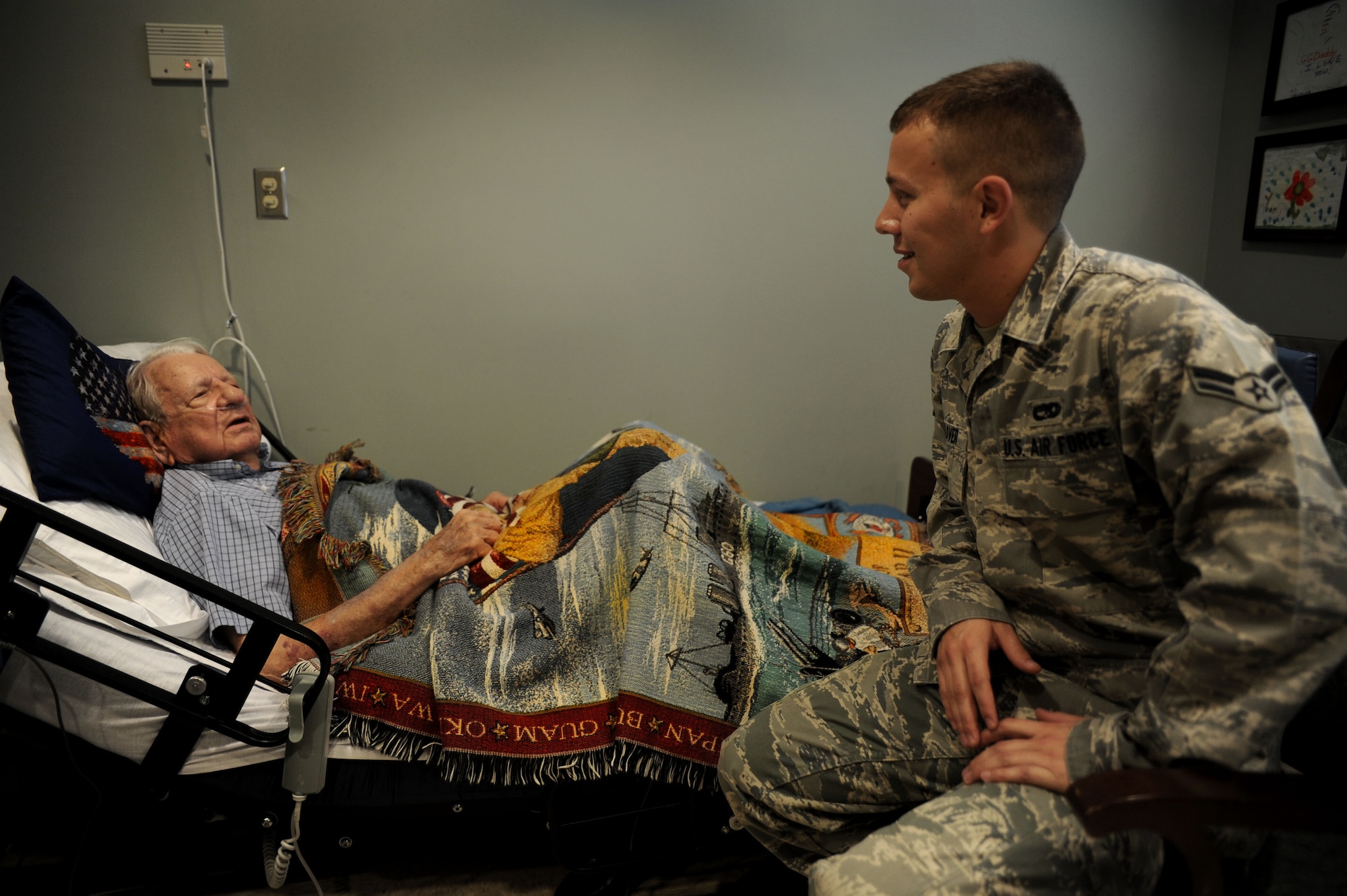 Airman 1st Class Aaron Glover visits with Clark Baker, a World War II veteran, at the Veterans Victory House Nursing Home in Walterboro, S.C., Oct. 14, 2010. Mr. Baker served in the Army as an infantryman with the 83rd Division, 329th Infantry, 2nd Battalion, Company D, 3rd Army from October 1942 to November 1946. During his time in service, Mr. Baker fought in the Battle of Normandy and the Battle of the Bulge and served his entire four-year enlistment in Central Europe. Mr. Baker now lives in the Veterans Victory House Nursing Home where his family members and loved ones frequently visit. Mr. Baker's wife of 68 years still lives in their home in Estill, S.C. Airman Glover is a rail specialist with the 437th Aircraft Maintenance Squadron. (U.S. Air Force Photo/Airman 1st Class Lauren Main)