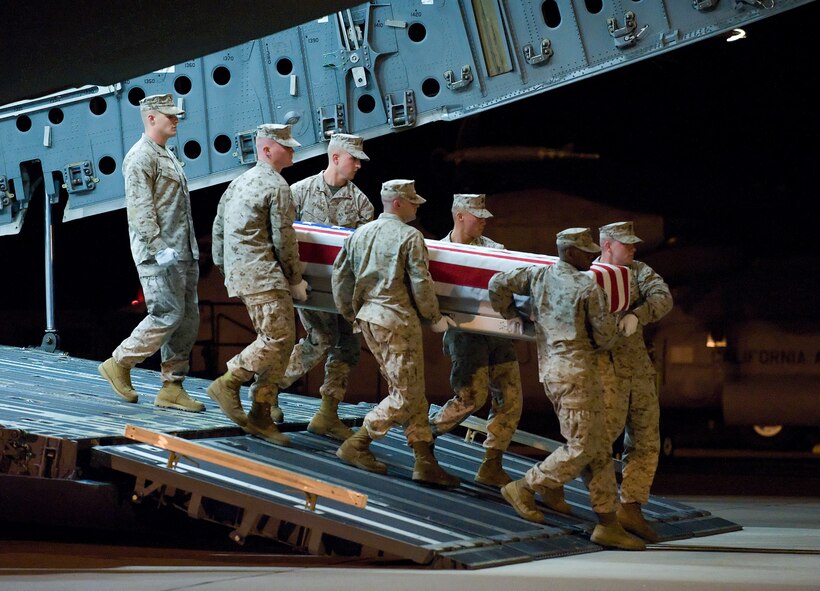 A U.S. Marine Corps carry team transfers the remains of Marine Lance Cpl. Raymon L. Johnson of Midland, Ga., at Dover Air Force Base, Del., Oct. 15, 2010. assigned to 1st Battalion, 8th Marine Regiment, 2nd Marine Division, I Marine Expeditionary Force, Camp Lejeune, N.C. (U.S. Air Force photo/Jason Minto)