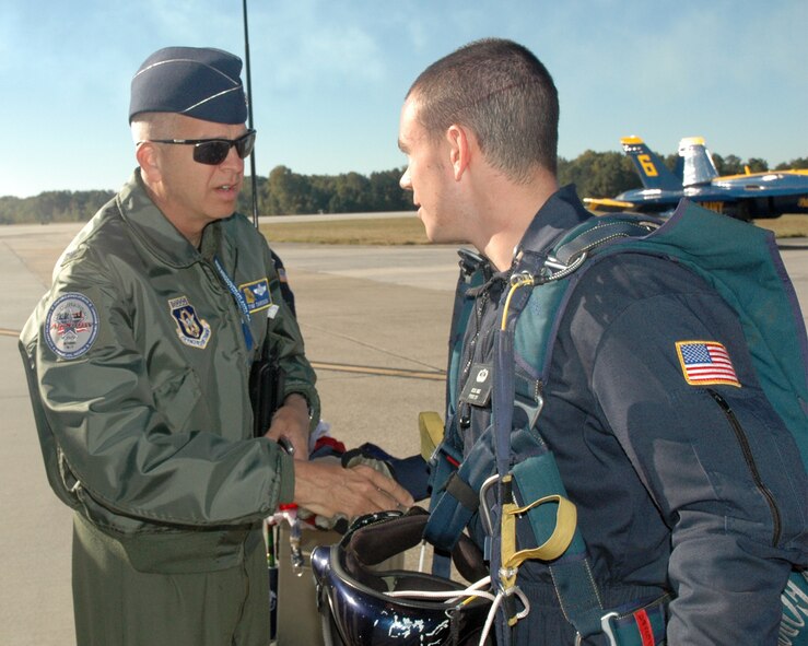 Col. Timothy E. Tarchick, 94th Airlift Wing Commander, presents a coin to a member of the Wings of Blue Air Force Parachute Demonstration team. (U.S. Air Force photo/Travon Dennis)
