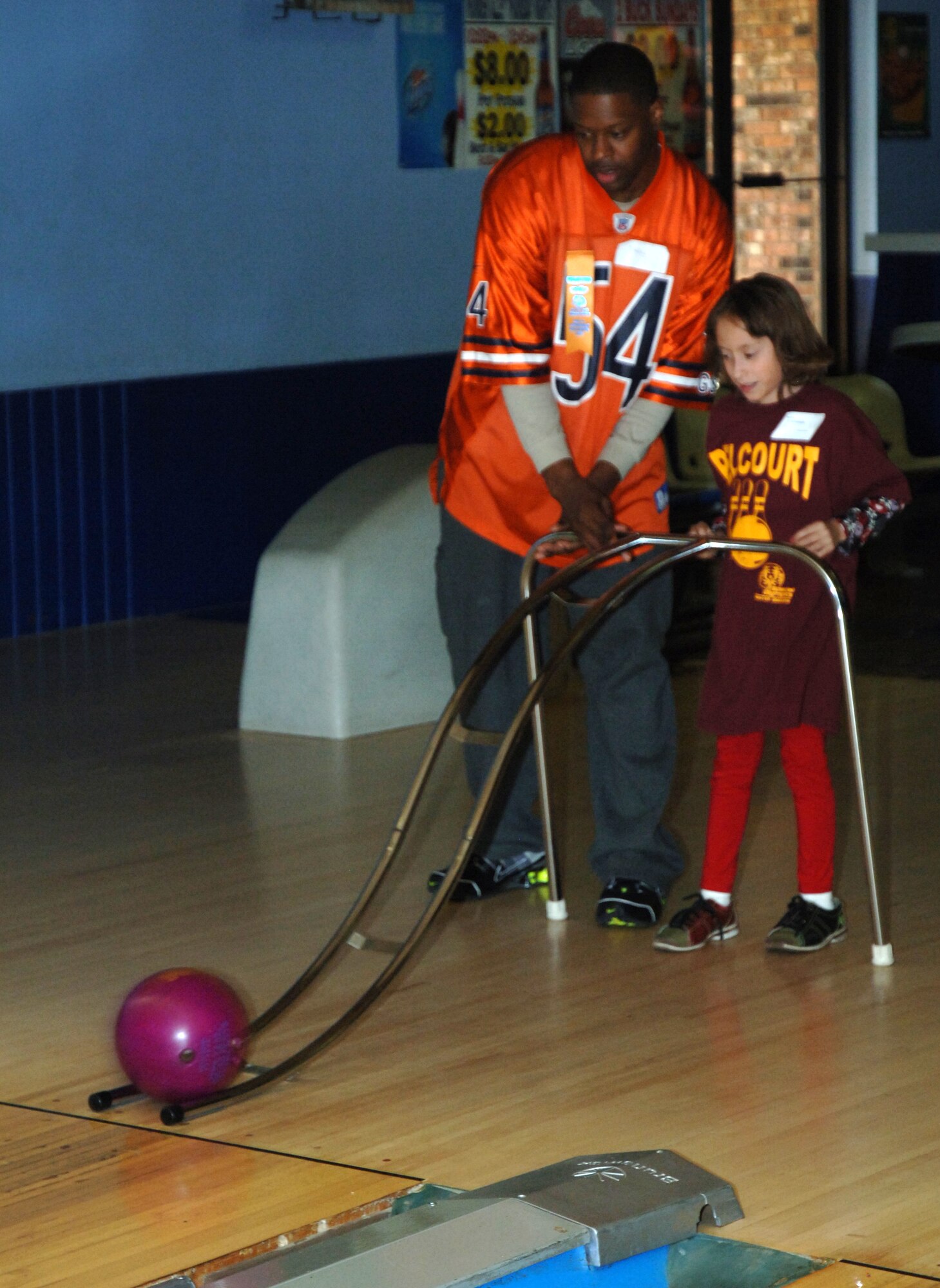 Staff Sgt. Timothy Oquinn, 319th Logistics Readiness Squadron, helps a Special Olympics participant bowl during a Special Olympics district bowling tournament Oct. 16 at Liberty Lanes in East Grand Forks, Minn. The Special Olympics offers year-round training and competition in 30 Olympic-type summer and winter sports and has been active in the Grand Forks, N.D., community since the mid-1970s. Members from the Grand Forks Air Force Base volunteered to help the participants bowl, award prizes and serve lunch. (U.S. Air Force photo by Airman 1st Class Rachel Waller) 