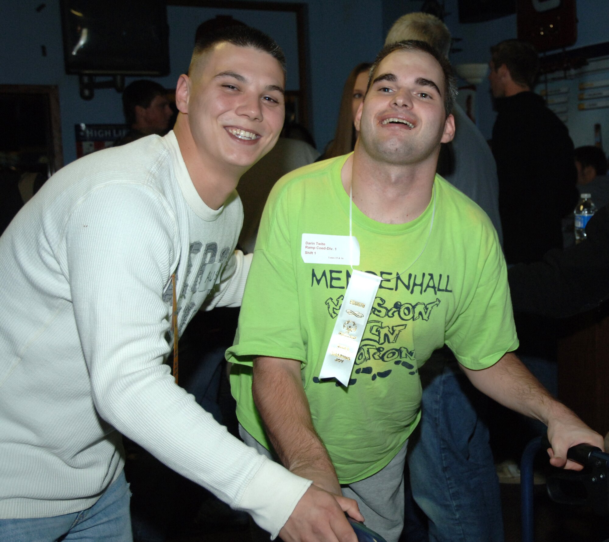 Senior Airman Austin Thomas, 319th Medical Group, poses for a picture with Darin Twite, a Special Olympics participant who won fourth place in his division, during a Special Olympics district bowling tournament Oct. 16 at Liberty Lanes in East Grand Forks, Minn. The Special Olympics offers year-round training and competition in 30 Olympic-type summer and winter sports and has been active in the Grand Forks, N.D., community since the mid-1970s. Members from the Grand Forks Air Force Base volunteered to help the participants bowl, award prizes and serve lunch. (U.S. Air Force photo by Airman 1st Class Rachel Waller) 