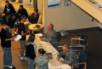 MINOT AIR FORCE BASE, N.D. -- Master Sgt. Richard Thomas, 17th Munitions Squadron first sergeant, and Master Sgt. Aaron Shearer, 5th Aircraft Maintenance Squadron assistant first sergeant, verify information with Airmen during Operation Prairie Hawk here Oct. 10. First sergeants from both the 5th Bomb Wing and the 91st Missile Wing in partnership with the Drug Demand Reduction Office, Air Force Office of Special Investigations and Judge Advocate General office conducted the sweep to present a clear deterrent to drug use. The ordered sweep is crucial to ensuring Airmen are fit for duty and key to meeting uncompromising adherence to all directives. (U.S. Air Force photo by Tech. Sgt. Lee A. Osberry Jr.)