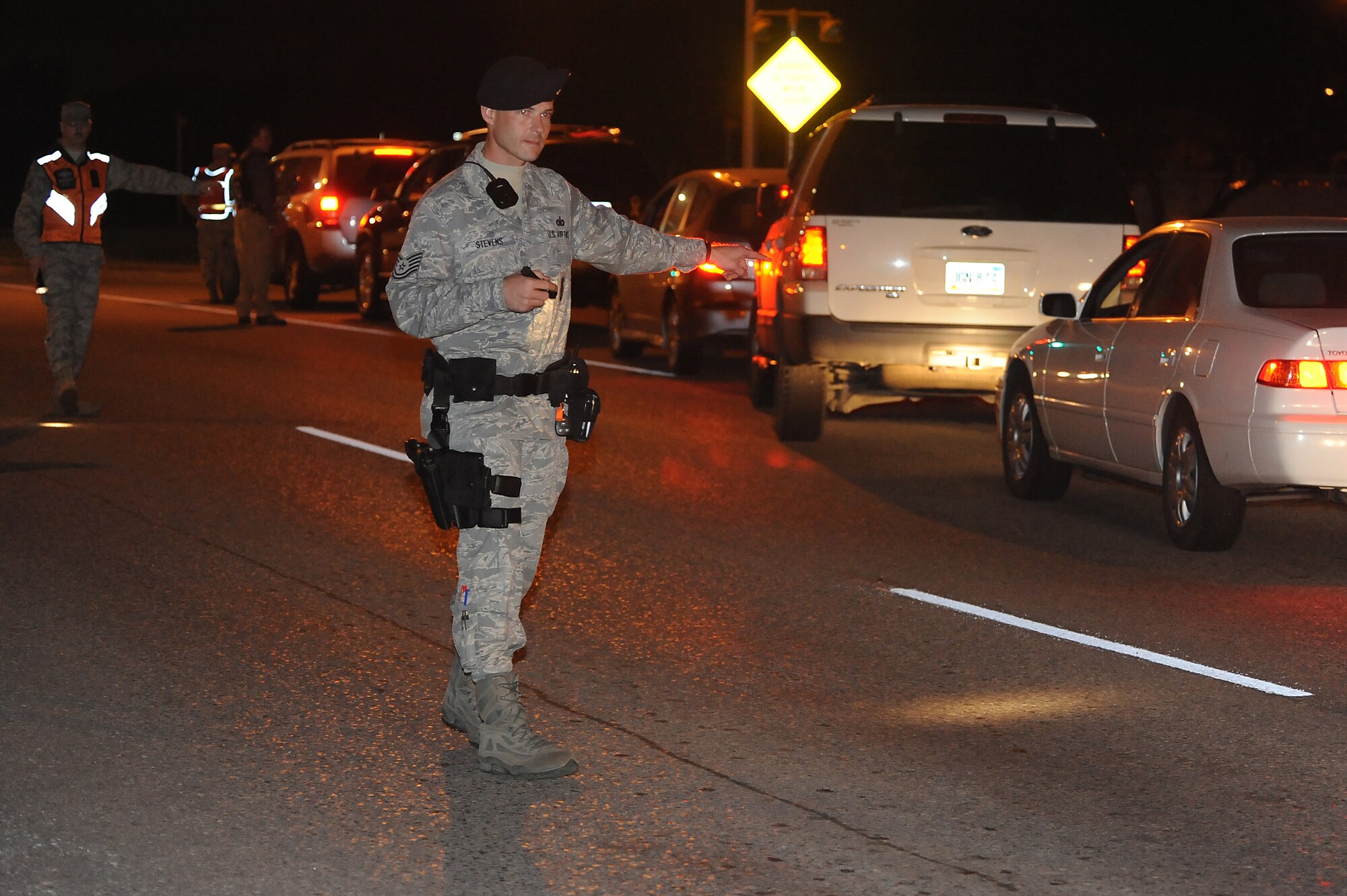 MINOT AIR FORCE BASE, N.D. -- Tech. Sgt. Chris Stevens, 5th Security Forces Squadron patrolman, directs traffic during Operation Prairie Hawk here Oct. 10. First sergeants from both the 5th Bomb Wing and the 91st Missile Wing in partnership with the Drug Demand Reduction Office, Air Force Office of Special Investigations and Judge Advocate General office conducted the sweep to present a clear deterrent to drug use. The ordered sweep is crucial to ensuring Airmen are fit for duty and key to meeting uncompromising adherence to all directives. (U.S. Air Force photo by Tech. Sgt. Lee A. Osberry Jr.)