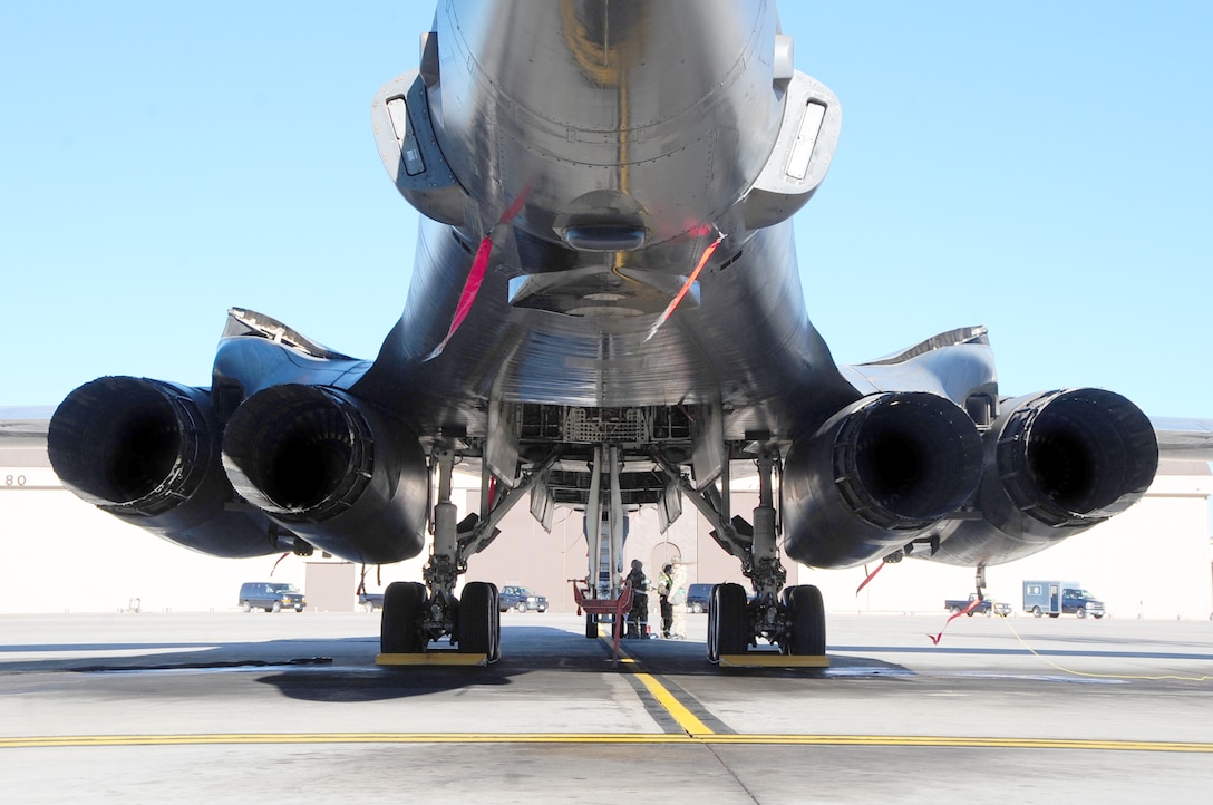 Airmen check over a technical order while working on a B-1B Lancer during a Phase II Operational Readiness Inspection Oct. 15, 2010, at Ellsworth Air Force Base, S.D.  Maintenance Airmen use the TO to ensure safety and accuracy. Airmen are assigned to the 28th Aircraft Maintenance Squadron.  (U.S. Air Force photo/Airman 1st Class Anthony Sanchelli)