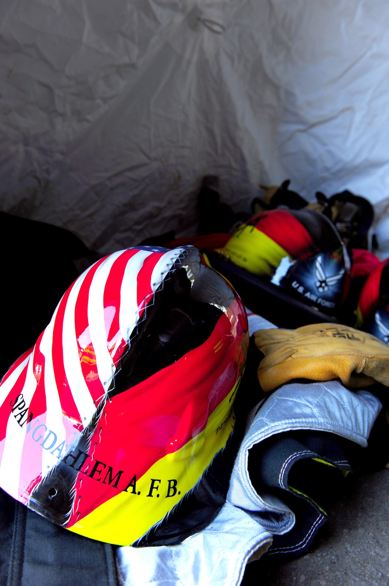 U.S. Air Forces in Europe firefighter helmets lay in a tent during a Firefighter Combat Challenge Oct. 9, 2010 at the 435th Construction and Training Squadron contingency training site at Ramstein Air Base, Germany. The competition consisted of a timed, five-part obstacle course. (U.S. Air Force photo/Airman 1st Class Brea Miller)