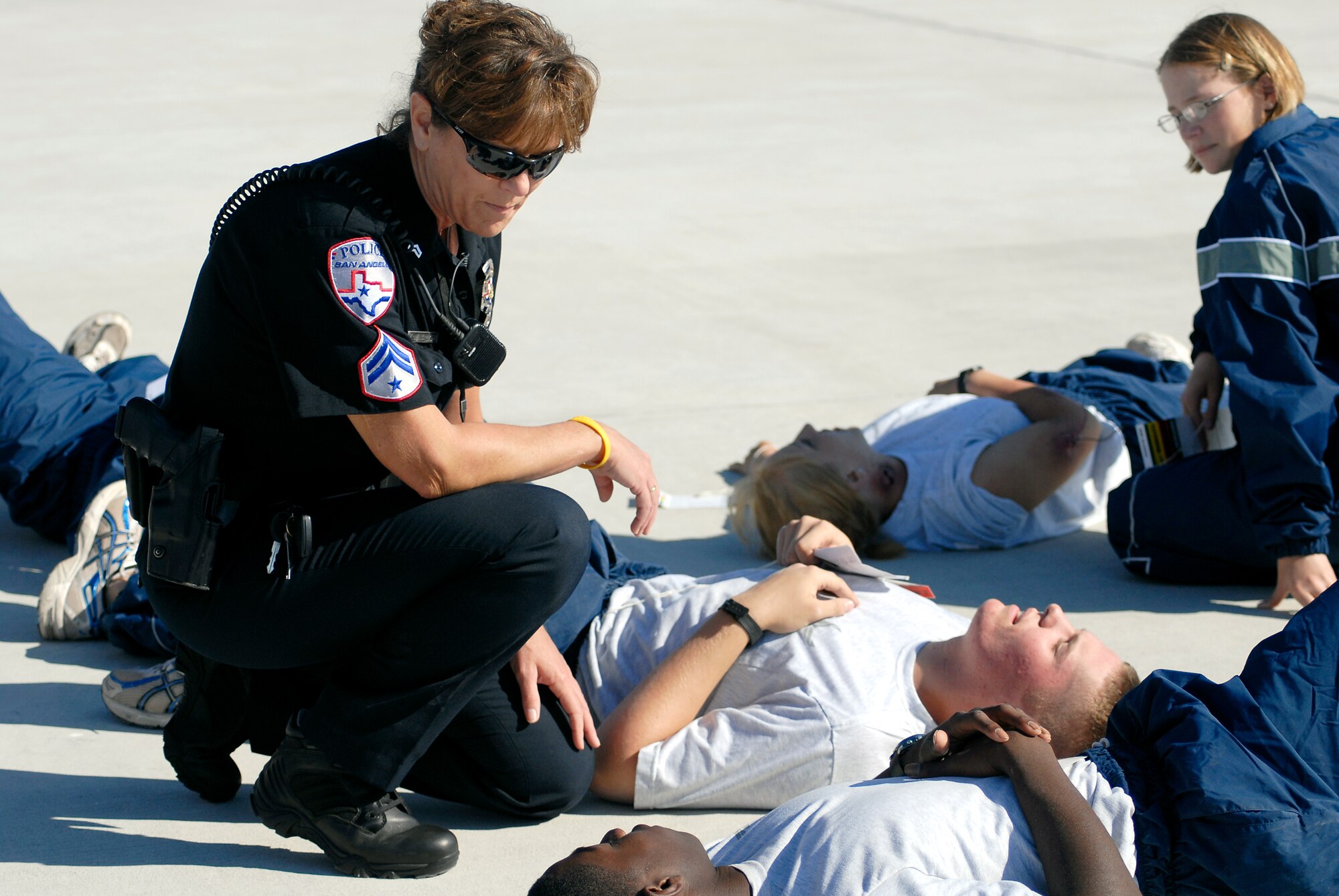 SAN ANGELO, Texas – Kathy Walker, San Angelo Police Department, sits with victims of the simulated aircraft crash scene during a training exercise at the Mathis Field San Angelo Regional Airport Oct. 14. Airmen from Goodfellow teamed up with emergency response teams from the Airport and city for the exercise. (U.S. Air Force photo/ Staff Sgt. Heather L Rodgers)