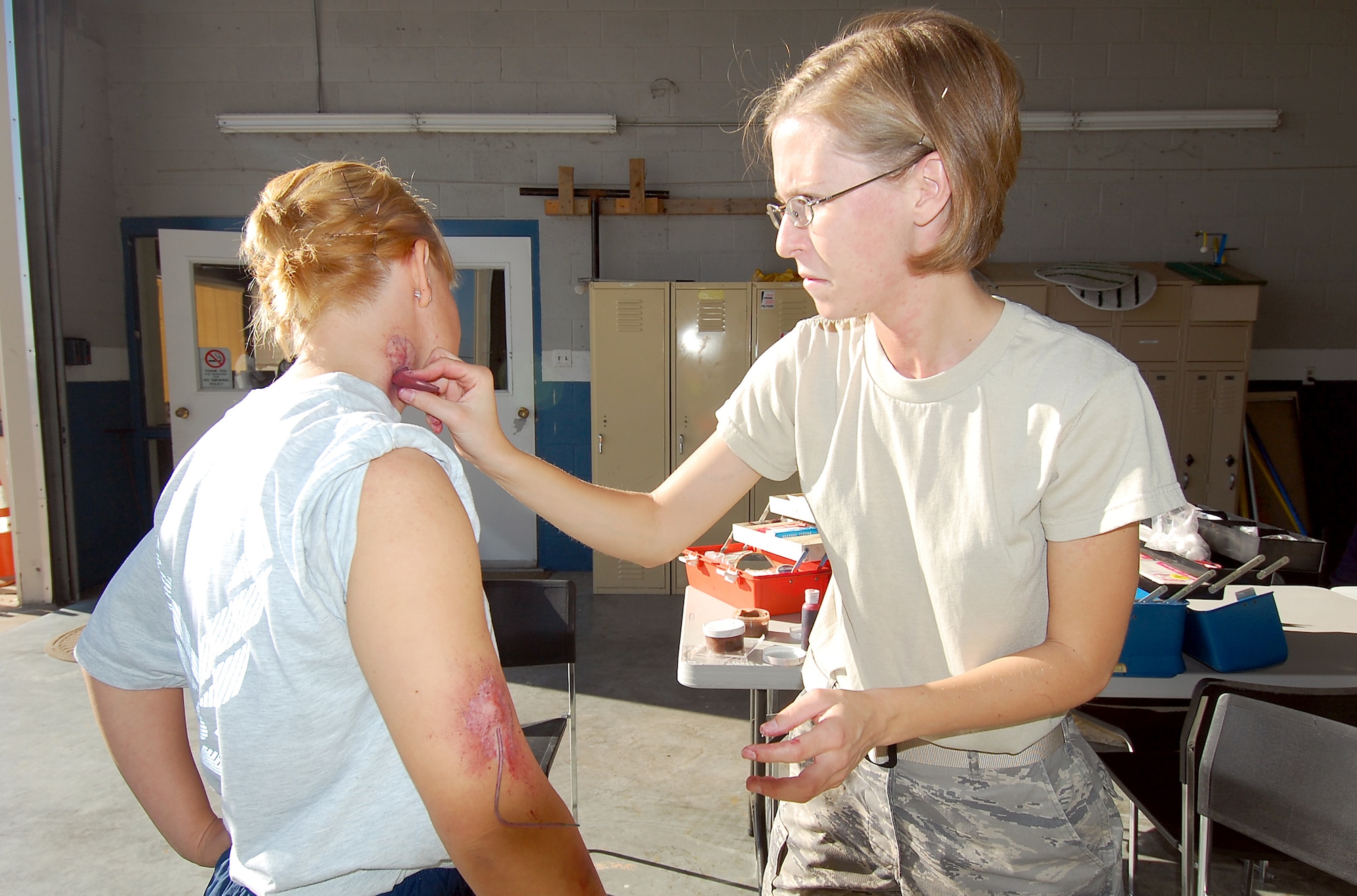 SAN ANGELO, Texas – Airman 1st Class Lauren Everett, 17th Medical Operations Squadron, prepares Airman 1st Class Laura Wood, 316th Training Squadron, for a training exercise at the Mathis Field San Angelo Regional Airport Oct. 14. Airmen from Goodfellow teamed up with emergency response teams from the Airport and city for the exercise which simulated a crash between a T-38 and civilian aircraft. (U.S. Air Force photo/ Staff Sgt. Heather L. Rodgers)