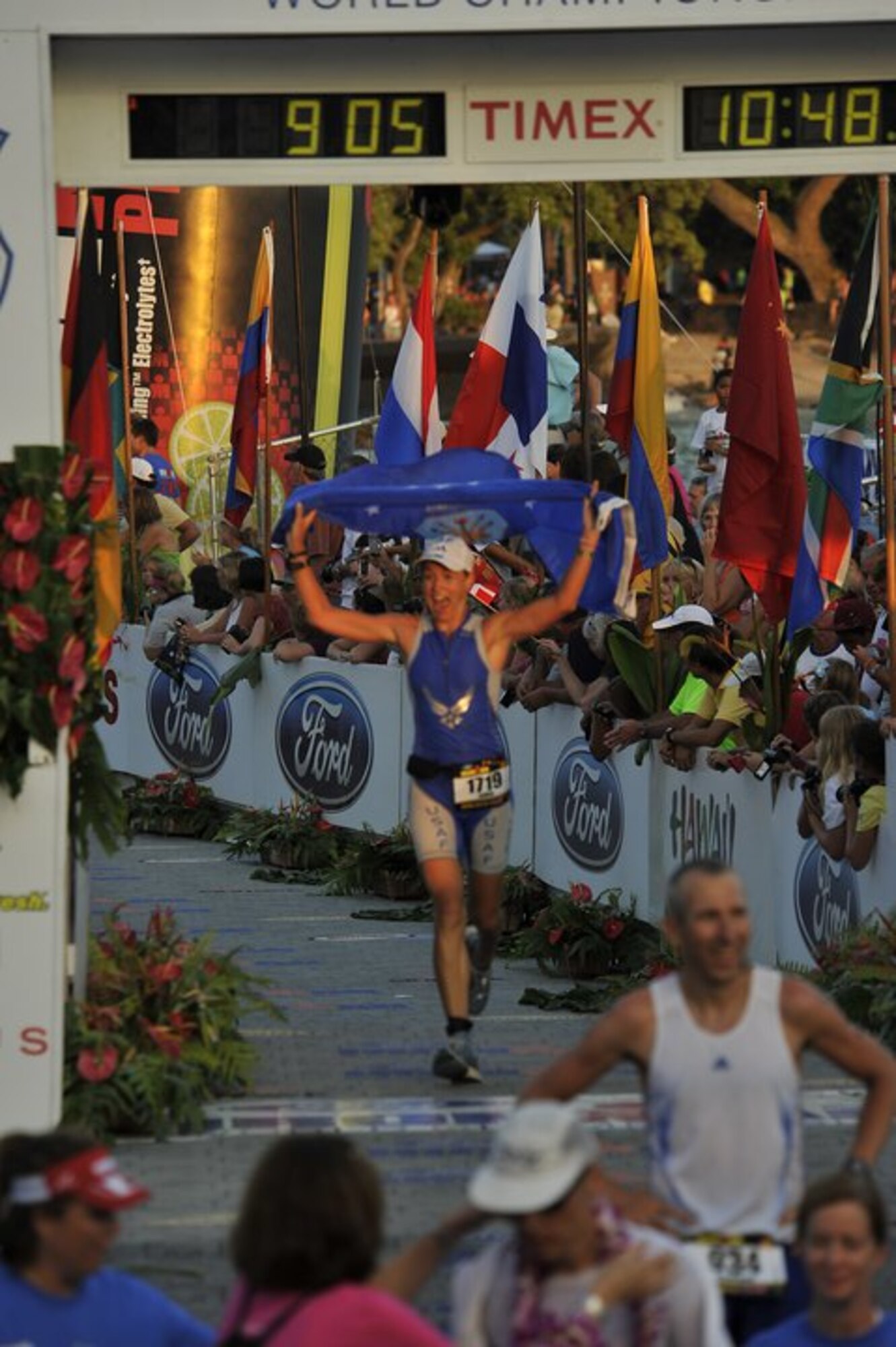 U.S. Air Force Capt. Jamie Turner crosses the finish line in 10:48:31 during the Ford Ironman World Championship Oct. 9, 2010 in Kona, Hawaii. During the race, Captain Turner endured a 2.4-mile swim, a 112-mile bike ride and a 26.2-mile marathon. Captain Turner is a pilot with the 315th Airlift Wing. (U.S. Air Force courtesy photo from the 2010 Ford Ironman World Championship)