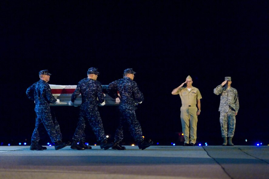 A U.S. Navy team transfers the remains of Navy Hospital Corpsman Edwin Gonzalez, of North Miami Beach, Fla., at Dover Air Force Base, Del., Oct. 10, 2010. Hospital Corpsman Gonzalez was assigned to 2nd Marine Division, Fleet Marine Forces, Atlantic, Camp Lejeune, N.C. (U.S. Air Force photo/Roland Balik)