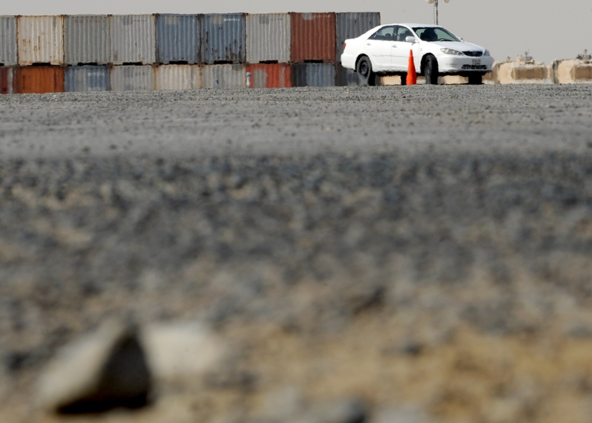 SOUTHWEST ASIA -- A student maneuvers a serpentine driving course on the flightline of an undisclosed location here Oct. 12. Other exercises presented during the Army Safe Driver Training include controlled-braking with vehicles that have standard and anti-lock braking systems; evasive maneuvering; navigation of a serpentine course that requires steering between cones in both forward and reverse; straight-line backing; and off-road recovery techniques. (U.S. Air Force photo by Senior Airman Laura Turner)