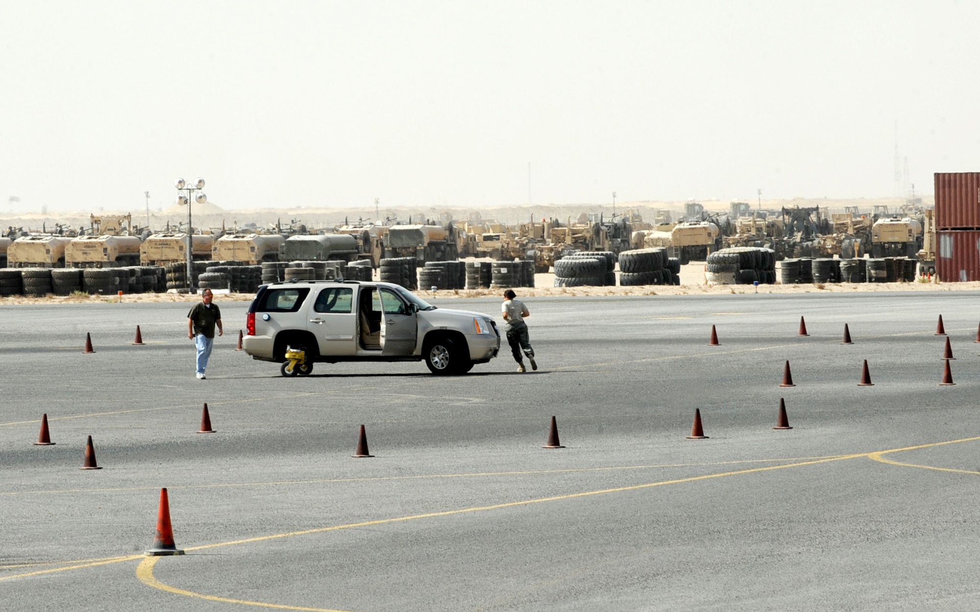 SOUTHWEST ASIA -- A student and an instructor switch places Oct. 12 during the Army Safe Driver Training here.  The course is designed to teach defensive-driving techniques that could save servicemembers' lives. Exercises presented during the course include controlled-braking with vehicles that have standard and anti-lock braking systems; evasive maneuvering; navigation of a serpentine course that requires steering between cones in both forward and reverse; straight-line backing; and off-road recovery techniques. (U.S. Air Force photo by Senior Airman Laura Turner)