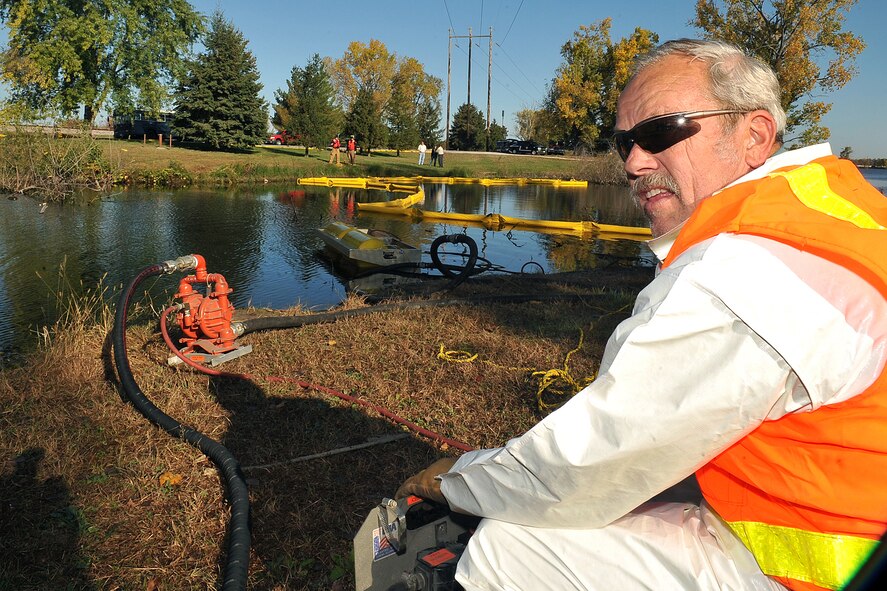 OFFUTT AIR FORCE BASE, Neb. - Walter Johnson, a water fuel maintainer with the 55th Civil Engineering Squadron, turns on an air compressor during a simulated hazardous material major accident response exercise at the base lake Oct. 15. This type of training allows various agencies to work on their response times, better coordinate with different organizations and sharpen their awareness and overall abilities if an accident were to happen. U.S. Air Force photo by Charles Haymond