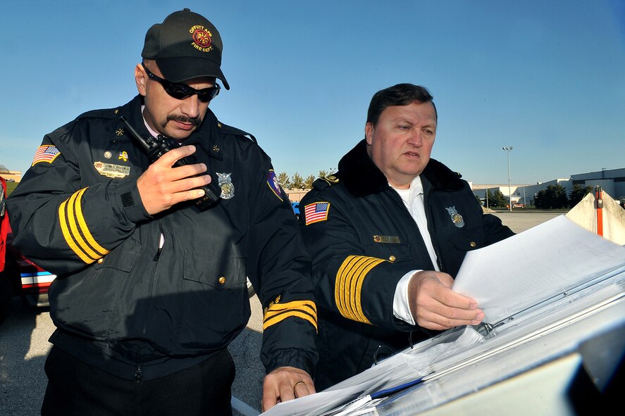 OFFUTT AIR FORCE BASE, Neb. - James Kuttner and Fire Chief David Eblin, both with the 55th Civil Engineering Squadron, relay information to different response agencies during a simulated hazardous material major accident response exercise here Oct. 15. This type of training allows various agencies to work on their response times, coordinating with different organizations, and sharpen their awareness if an accident in this magnitude happened at Offutt.  U.S. Air Force photo by Charles Haymond