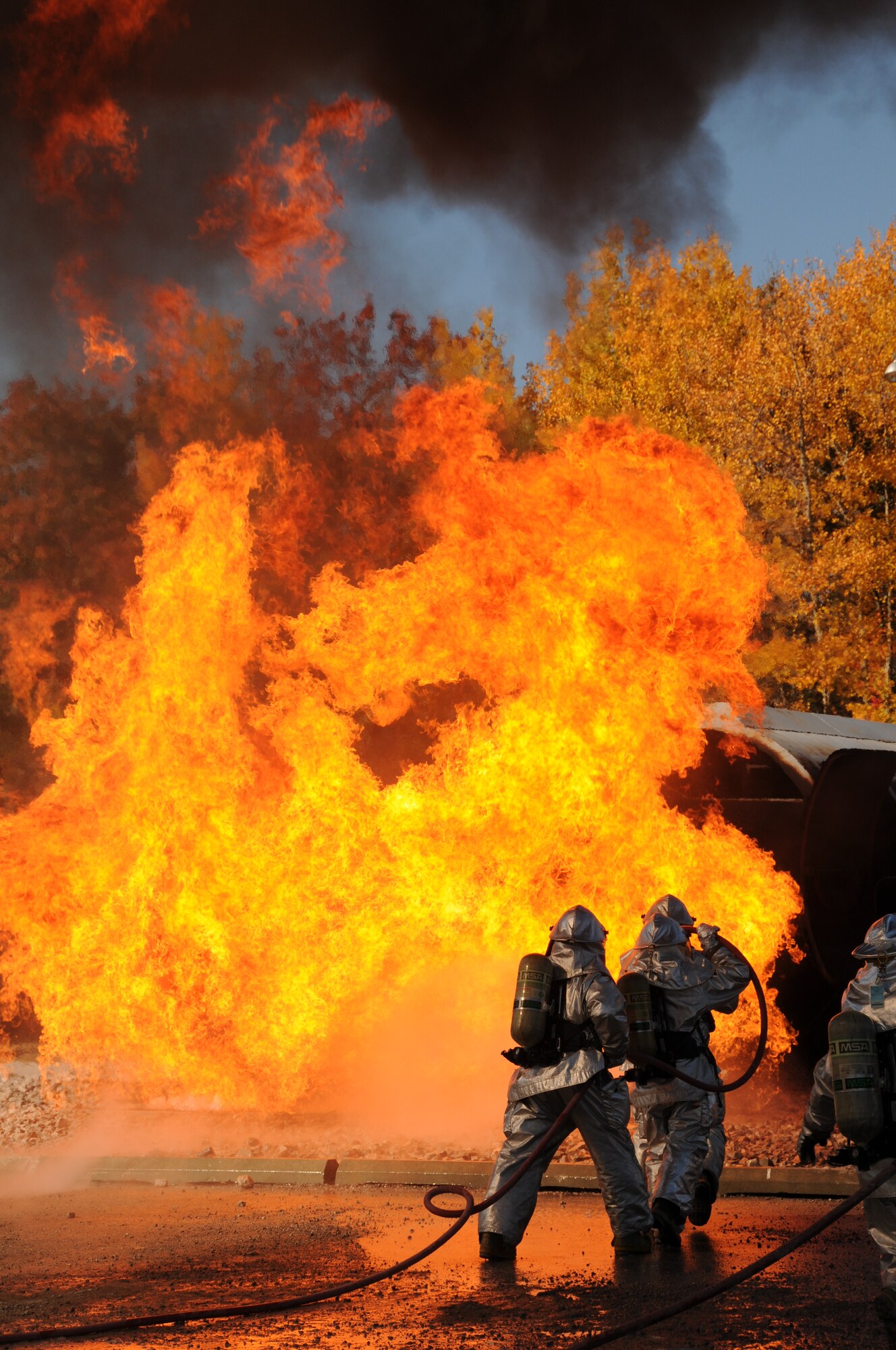 U.S. Air Force firefighters from the 180th Fighter Wing, extinguish an aircraft fire during a training exercise at the Phelps Collins Combat Readiness Training Center, Alpena, Michigan, October 15, 2010.  Firefighters from the 180 FW are doing annual training to prepare them for various rescue situations. (U.S. Air Force photo by Senior Airman Amber Williams/Released)