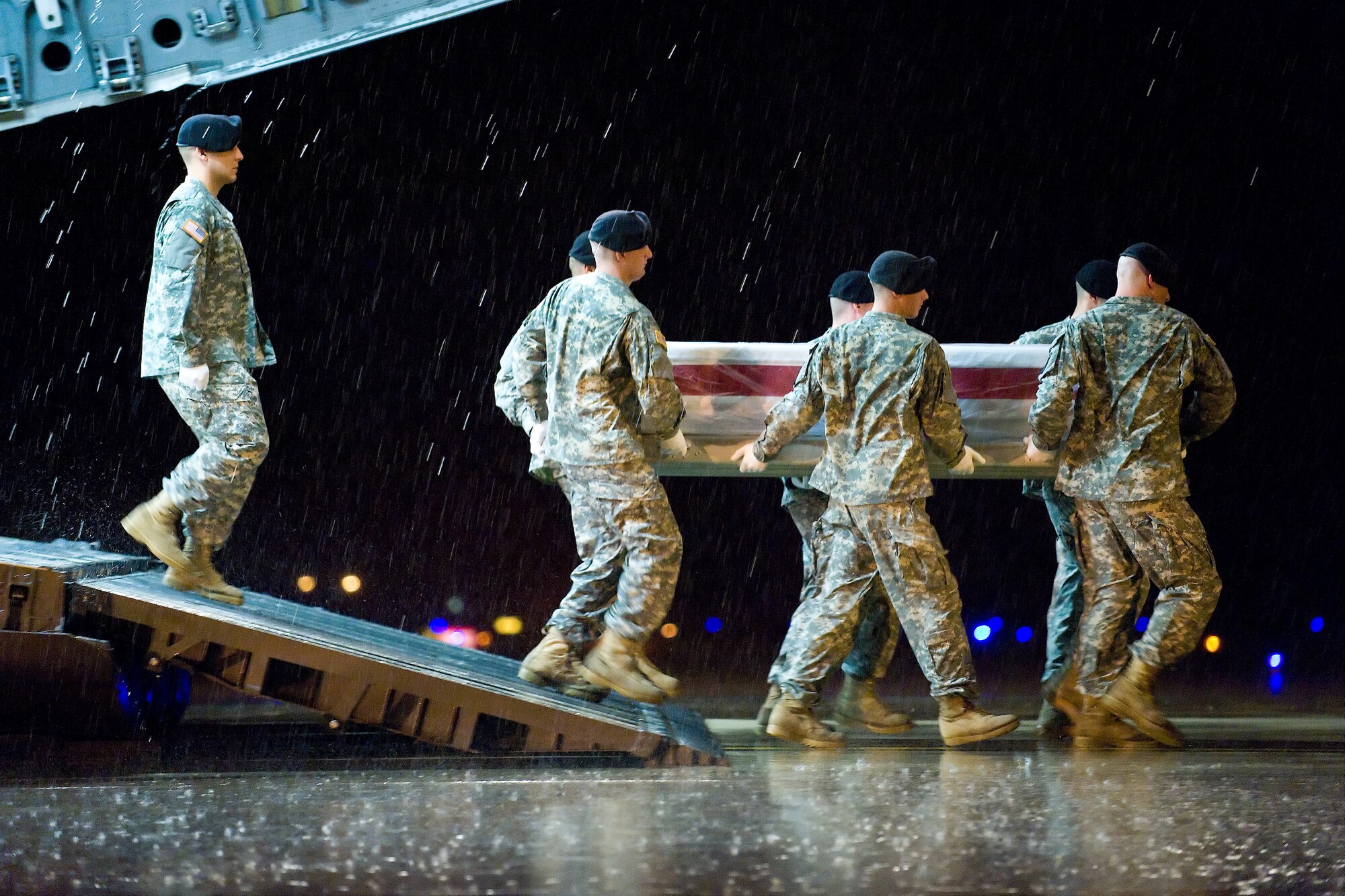 A U.S. Army carry team transfers the remains of Army Sgt. Justin A. Officer, of Wichita, Kan., at Dover Air Force Base, Del., Sept. 30, 2010. Officer was assigned to the 1st Squadron, 75th Cavalry Regiment, 2nd Brigade Combat Team, 101st Airborne Division (Air Assault), Fort Campbell, Ky. (U.S. Air Force photo/Roland Balik)