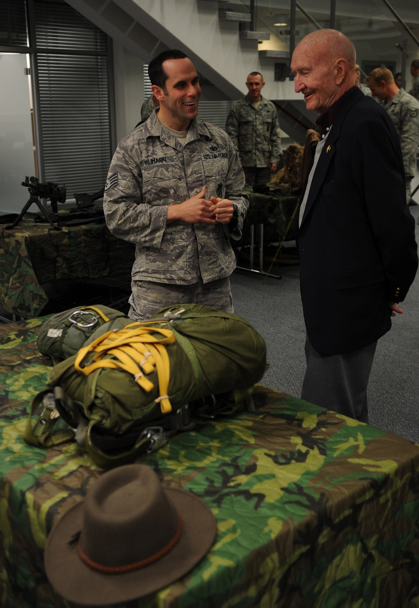 U.S. Air Force Staff Sgt. Joseph Klimaski, 435th Security Forces Squadron, speaks with retired Col. Gail Halvorsen during a tour of the 435th Contingency Readiness Group, Ramstein Air Base, Germany, Oct. 15, 2010. Colonel Halvorsen, also known as the Berlin Candy Bomber, flew C-54 Skymasters during the Berlin Airlift and parachuted candy to children from his airplane. (U.S. Air Force photo by Senior Airman Caleb Pierce)