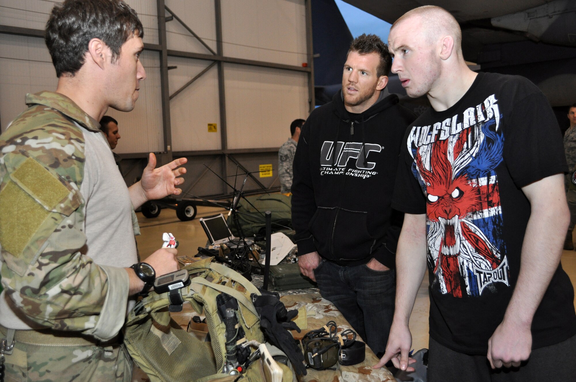RAF MILDENHALL, England -- A combat controller from the 352nd Special
Operations Group, explains how some of the equipment he carries is used to
mixed martial arts fighters Ryan Bader, left, and Aaron Wilkinson during
their visit to the group, Oct. 14, 2010.  Bader and Wilkinson were two of
three MMA fighters visiting the 352nd SOG while in the local area for an
event.  (U.S. Air Force photo/Tech. Sgt. Marelise Wood) 