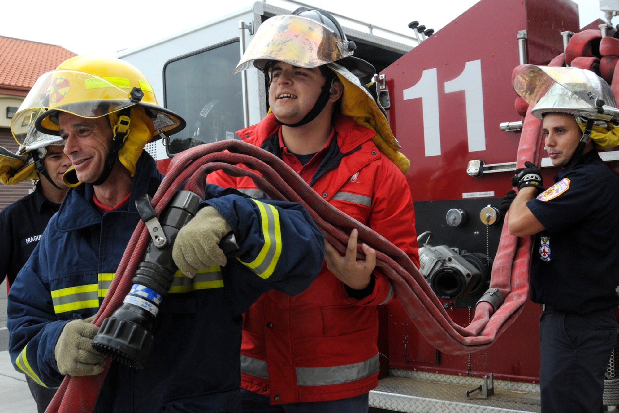 Pedro Barcelos, a local volunteer firefighter from Praia da Vitoria, looks a at a three-inch hose on the back of an Air Force fire truck, Oct. 9, 2010.  The Air Force uses equipment that is different from off-base besides the fact the Air Force uses inches and feet and the Azores, Portugal use centimeter and meters. (U.S. Air Force photo by Tech. Sgt. Chyrece Campbell)
