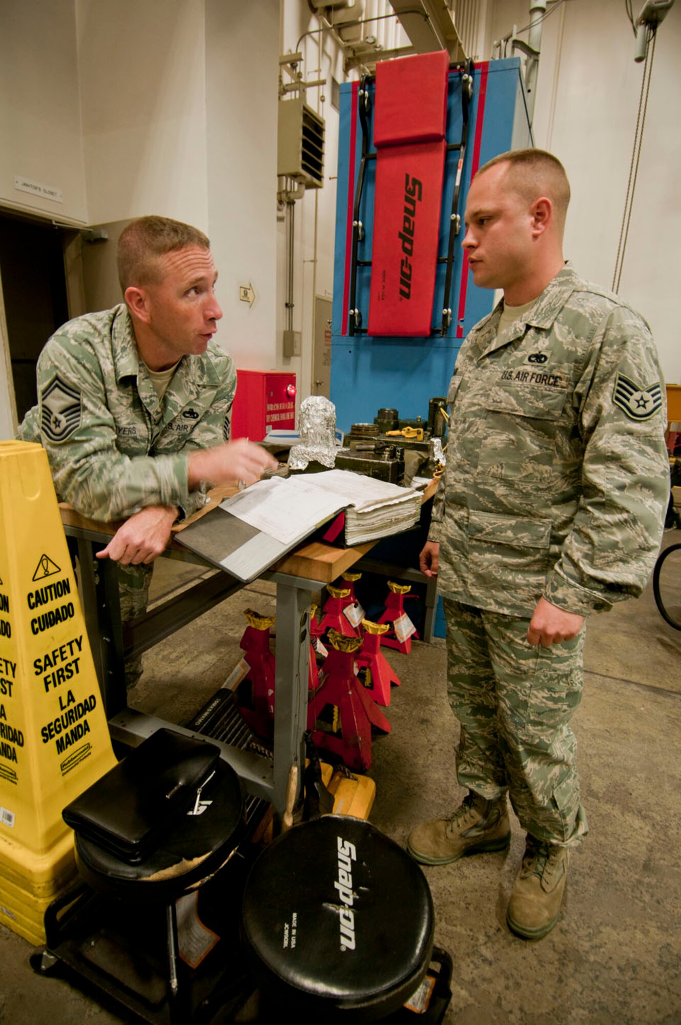 Senior Master Sgt. Ken Myers, Air Combat Command’s Logistics Compliance Assessment Program inspector talks to Staff Sgt. Christopher Starr, 35th Maintenance Group Quality Assurance inspector, about examining technical orders prior to a QA inspection, Oct. 18, 2010, at Misawa Air Base, Japan. The 35th MXG will undergo approximately 30 days of maintenance evaluations during the LCAP inspection, Oct. 18 to 22. (U.S. Air Force photo/Senior Airman Jessica Lockoski/Released)