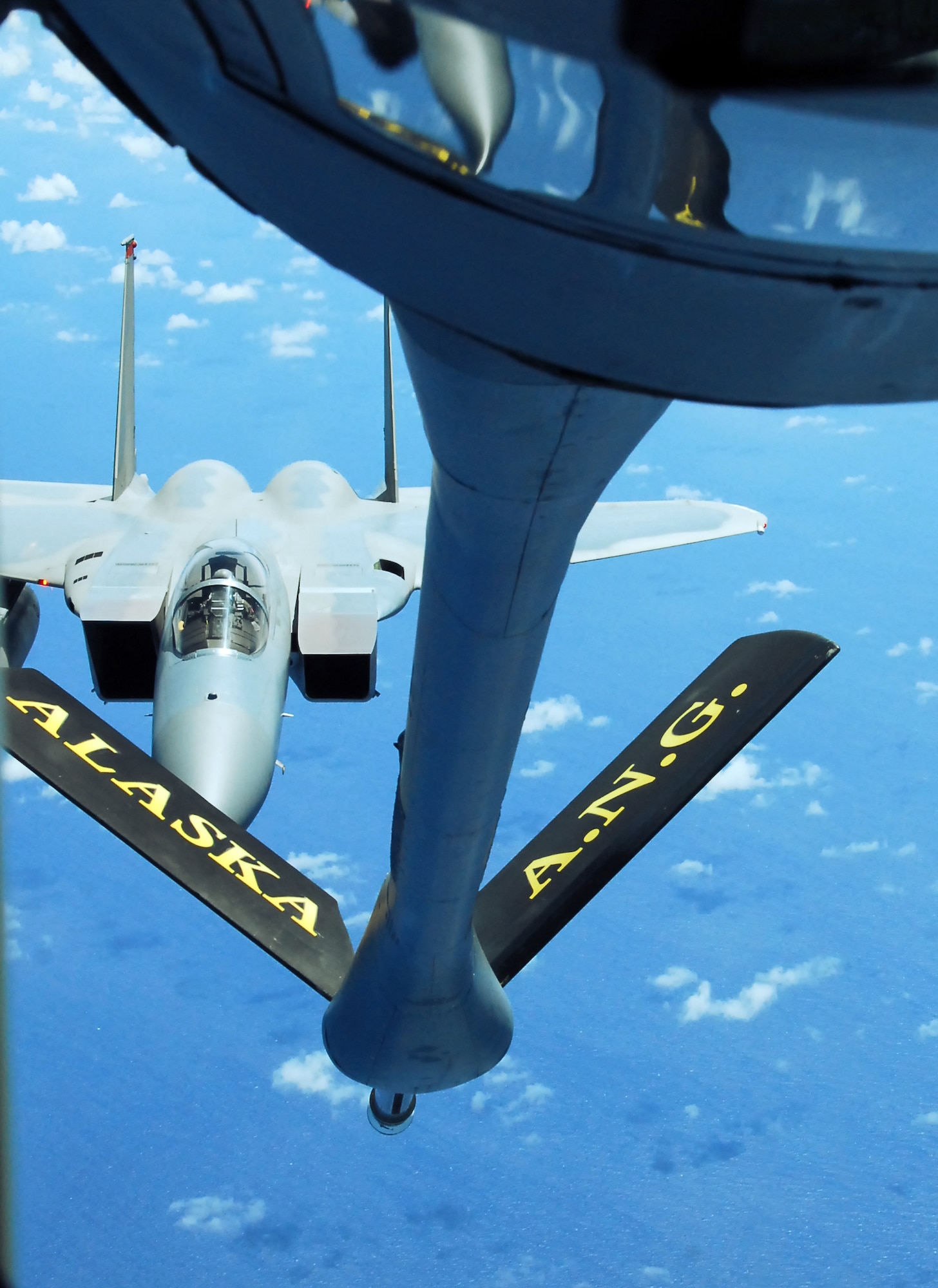 506th Expeditionary Air Refueling Squadron, an Air National Guard unit deployed here from the 168th Air Refueling Wing, Alaska, perform a midair refueling mission on an F-15 here. The 168th is deployed here in support of the continuous bomber presence and theater security packages in the Pacific region. (U. S. Air Force photo/Airman Whitney Amstutz)