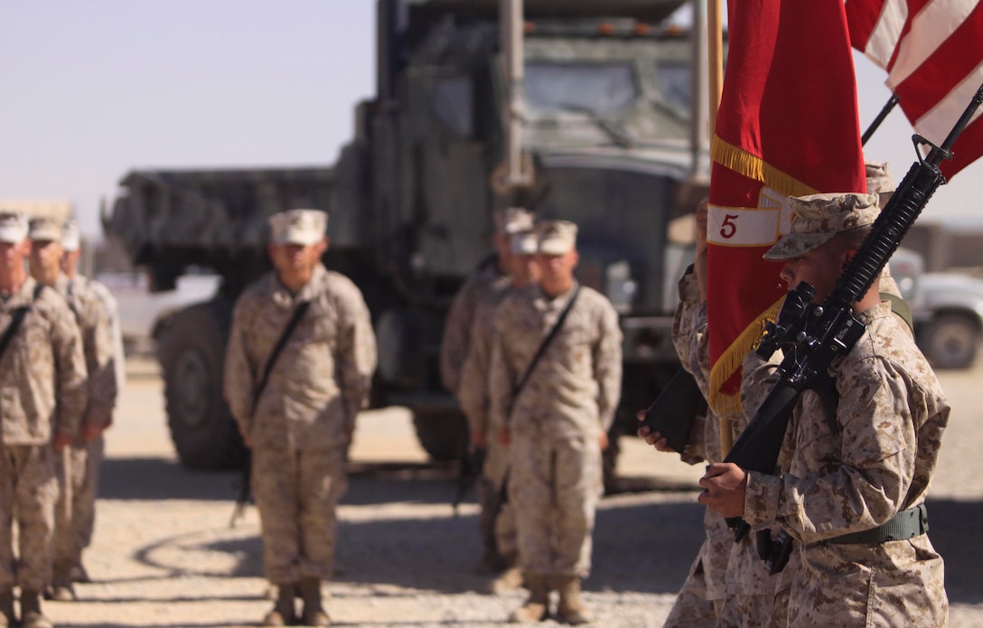 The Combat Logistics Battalion 5 Color Guard marches past a formation of CLB-3, 1st Marine Logistics Group (Forward) personnel during a transfer of authority ceremony at Camp Dwyer, Afghanistan, Oct. 18. While deployed, the Marines and sailors of CLB-3, 1st MLG (FWD), will provide combat logistical support to Regimental Combat Team 1.