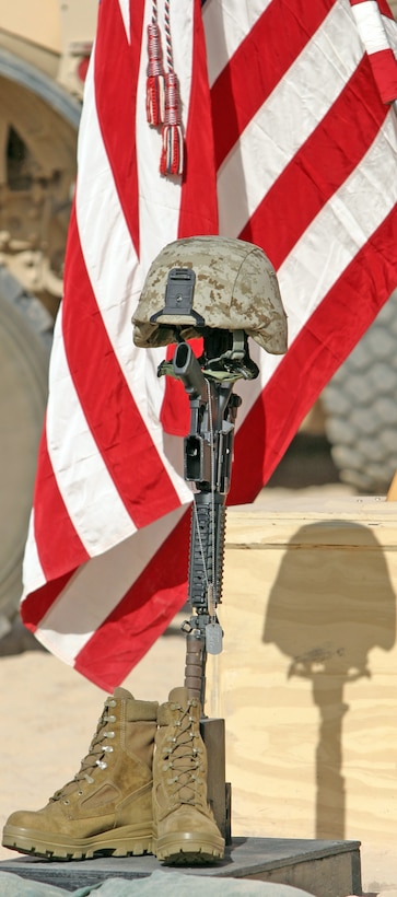 A battlefield memorial cross rifle display honoring Sgt. Frank R. Zaehringer, an anti-tank missile-man with Weapons Company, 2nd Battalion, 9th Marine Regiment, stands at attention, Oct. 19, during a memorial service at Forward Operating Base Camp Hanson, Helmand Province, Afghanistan. Zaehringer’s life was tragically ended Oct. 11, while conducting combat operations in Northern Marjah.