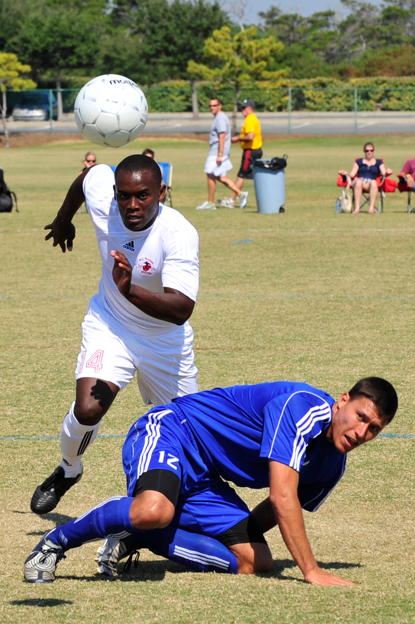 U.S. Marine Corps Private 1st Class Tinashe Ngwenya, assigned to Marine Corps Base Camp Butler, Okinawa,  Japan, a member of the USMC soccer team, runs for the ball while U.S. Air Force Capt. Robert Wible, assigned to Eglin AFB, Fla., recovers from a head ball during a 2010 Armed Forces Soccer Championship Round Robin match, Destin Fla., Oct. 19, 2010. Each team conducted highly competitive training programs and trial camps in order to select the best players to represent their respective services.  However, at the conclusion of the tournament, inter-service rivals will cast aside their differences.  The top players from the tournament will be chosen to represent the US in the International Military Sports Competition. (DoD Photo by Staff Sgt. Stephanie Jacobs/RELEASED)


