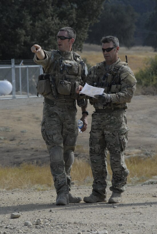 Pararescuemen from the 131st Rescue Squadron plan for an upcoming rescue scenario outside an urban assault course during exercise Soaring Angel 10-2 Oct. 1, 2010 at Fort Hunter Liggett, Calif. Soaring Angel is the 129th Rescue Wing's tactical training exercise that prepares Airmen for an upcoming Operational Readiness Inspection. (Air National Guard photo by Airman 1st Class Jessica Green)