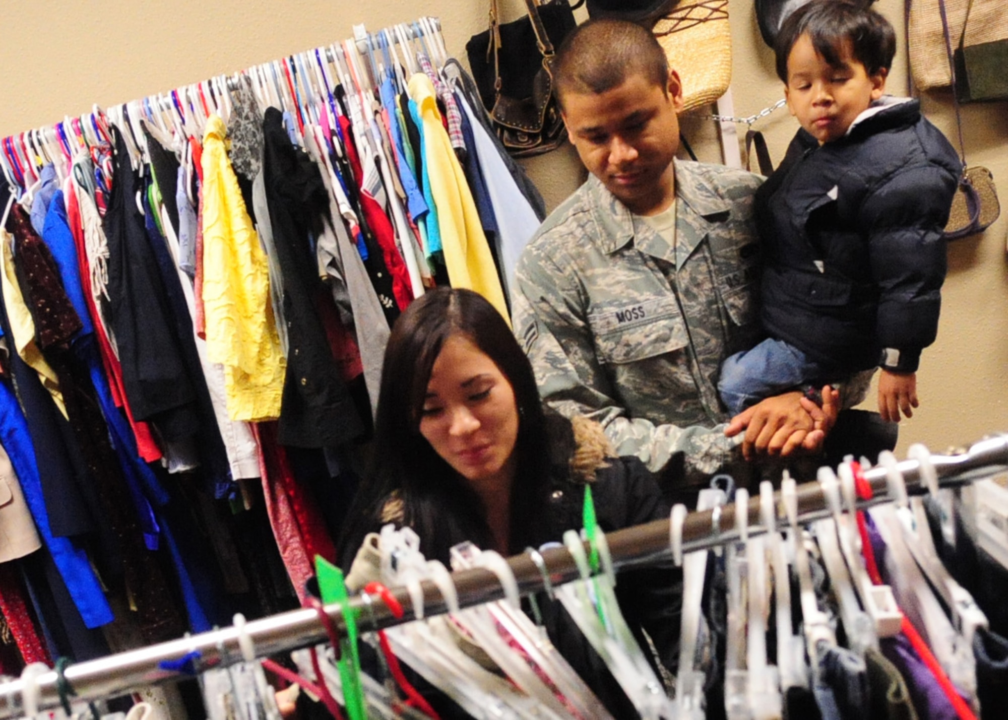 Airman 1st Class Marvin Moss and his family browse through clothes at the Airmen's Attic Oct. 15, 2010, Eielson Air Force Base, Alaska. The Airmen's Attic is run by the Top 3 with the help of 5/6 and Airman Committed to Excellence. Airman Moss is a 354th Maintenance Squadron nondestructive inspection journeyman. (U.S. Air Force photo/Airman 1st Class Laura Goodgame)