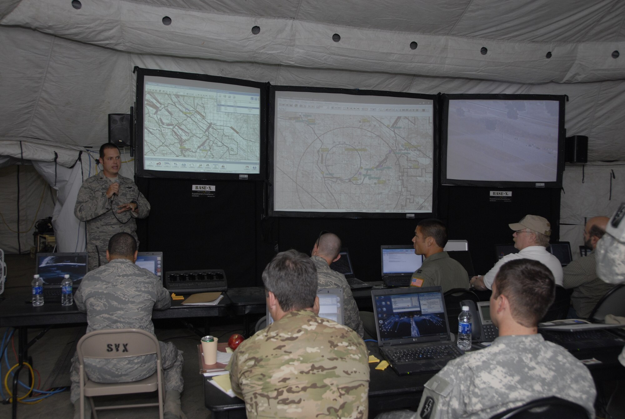 Maj. Mathew Wenthe, the assistant director of operations for weapons and tactics with the 129th Rescue Squadron, briefs members of the Rescue Operations Center at the forward operating base set up for exercise Soaring Angel 10-2 at Fort Hunter Liggett, Calif. Oct. 2, 2010 about the hostage recovery scenario being conducted by members from the 129th Rescue Squadron's HH-60G Pave Hawk rescue helicopter teams, the 130th Rescue Squadron C-130P Combat Shadow crews and the 131st Rescue Squadron's guardian angel players. Soaring Angel is the 129 Rescue Wings tactical training exercise in preparation for their upcoming Operational Readiness Inspection in Dec. 2011. (Air National Guard photo by Airman 1st Class Jessica Green)