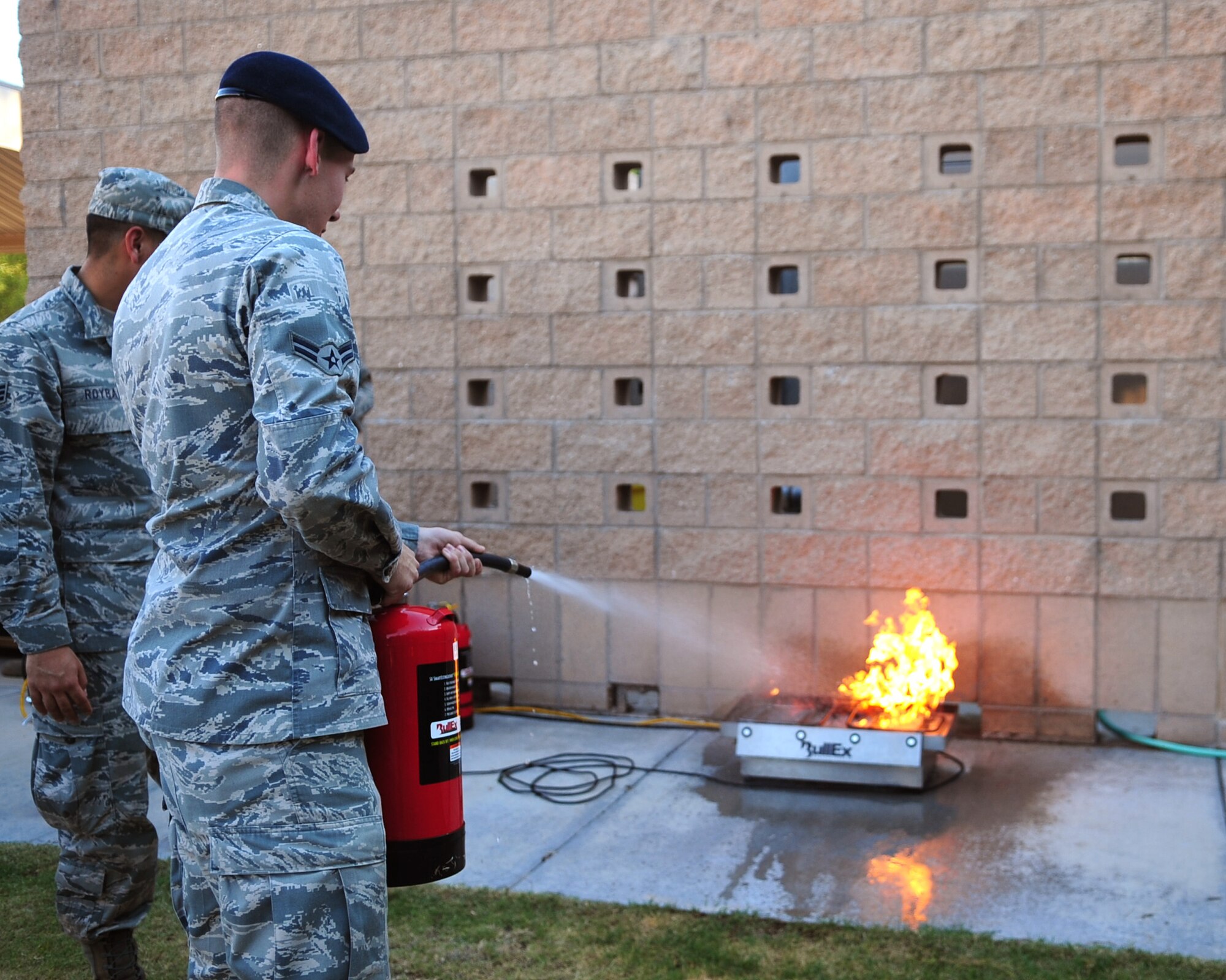 DAVIS-MONTHAN AIR FORCE BASE, Ariz. - An Airman from the 355th Security Forces Squadron demonstrates proper procedures when utilizing a fire distinguisher here Oct. 7, 2010. Hosted by the Davis-Monthan fire and emergency services flight, this served as a training event in which the fire fighters staged common scenarios and Airmen were asked to identify potential fire hazards. The theme for National Fire Prevention Week this year is ‘Beep! Beep! Beep! Smoke Alarms: A sound you can live with” highlights the importance of fire safety within the home. (U.S. Air Force photo/Airman 1st Class Jerilyn Quintanilla)