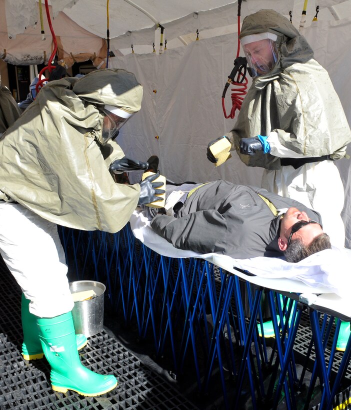 ANDREWS AIR FORCE BASE, Md. -- Two decon team members from the 79th Medical Wing scrub a patient to remove hazardous contaminants during the Capital Shield 11 Exercise  Oct. 13 here. (U.S. Air Force photo/Melanie Moore)