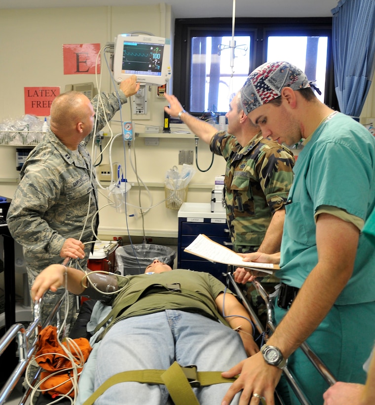 ANDREWS AIR FORCE BASE, Md. -- Captains Brian Santos and John Plott, 79th Medical Wing nurses in the Post Anesthesia Care Unit, set up a patient’s cardiac monitor while Capt. Thomas Borsari, a staff anesthesiologist, performs a thorough patient assessment during the Capital Shield 11 Exercise Oct. 13 here.  The PACU evaluates patients before and after they are taken to the operating room for surgery. (U.S. Air Force photo/Melanie Moore)