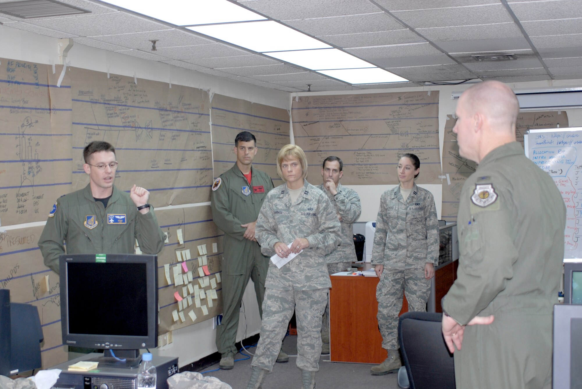 Capt. Christopher Moeller (left) briefs Col. Patrick C. Malackowski (far right) during an Air Force Smart Operations for the 21st Century Rapid Improvement Event Oct. 8, 2010, at Osan Air Base, South Korea. Captain Moeller is assigned to the 51st Fighter Wing and Colonel Malackowski is the 51st FW commander. (U.S. Air Force photo/Staff Sgt. Eric Burks)
