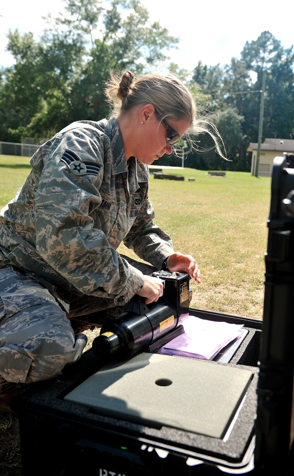 Senior Airman Katie Hamm prepares equipment during a hostage training exercise Oct. 13, 2010, at Moody Air Force Base, Ga. Airmen from the 23rd Civil Engineer Explosive Ordnance Disposal Flight tested the ability of their new Bomb Squad Emergency Response Vehicle during the exercise. Airman Hamm is an EOD technician assigned to the 23rd CE EOD Flight. (U.S. Air Force photo/Airman 1st Class Joshua Green) 