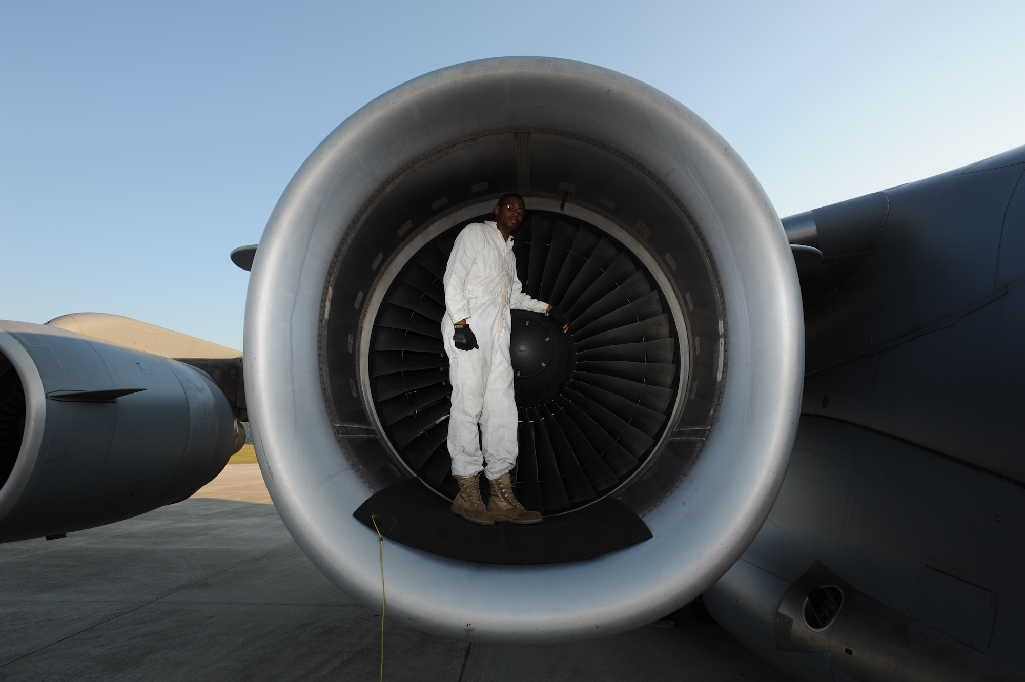 Staff Sgt. Jonathan Solomon, 15th Aircraft Maintenance Squadron flying crew chief, performs a pre-flight inspection on a C-17 engine at Fort Benning, GA Oct. 10. A C-17 Globemaster III from the 15th Wing at Joint Base Pearl Harbor-Hickam made the long journey to Fort Benning to support the student jump requirements of the 507th Airborne School. (U.S. Air Force photo/Staff Sgt. Nathan Allen) 
