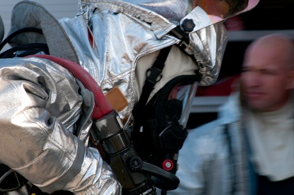 Members of the 139th Airlift Wing, Missouri Air National Guard, Civil Engineering, Fire Department, run through an obstacle coarse, October 17, 2010, at Rosecrans Memorial Airport in Saint Joseph MO. The firefighters perform the tasks as part of annual training. (U.S. Air Force photo by Senior Airman Sheldon Thompson/Released)