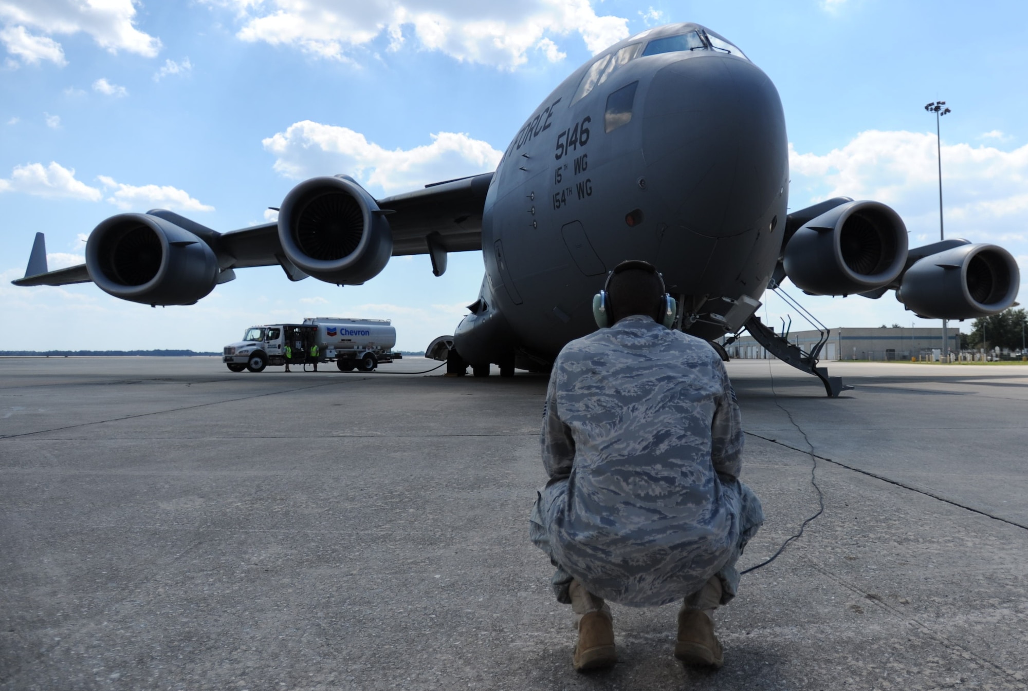 Staff Sgt. Jonathan Solomon, 15th Aircraft Maintenance Squadron flying crew chief, performs a pre-flight inspection on a C-17 in to prepare for transit to Fort Benning, GA from Orlando, FL Oct. 10. A C-17 Globemaster III from the 15th Wing at Joint Base Pearl Harbor-Hickam made the long journey to Fort Benning to support the student jump requirements of the 507th Airborne School. (U.S. Air Force photo/Staff Sgt. Nathan Allen) 
