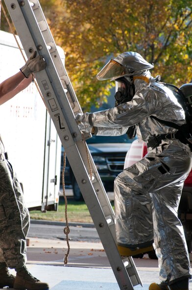 Members of the 139th Airlift Wing, Missouri Air National Guard, Civil Engineering, Fire Department, run through an obstacle coarse, October 17, 2010, at Rosecrans Memorial Airport in Saint Joseph MO. The firefighters perform the tasks as part of annual training. (U.S. Air Force photo by Senior Airman Sheldon Thompson/Released)