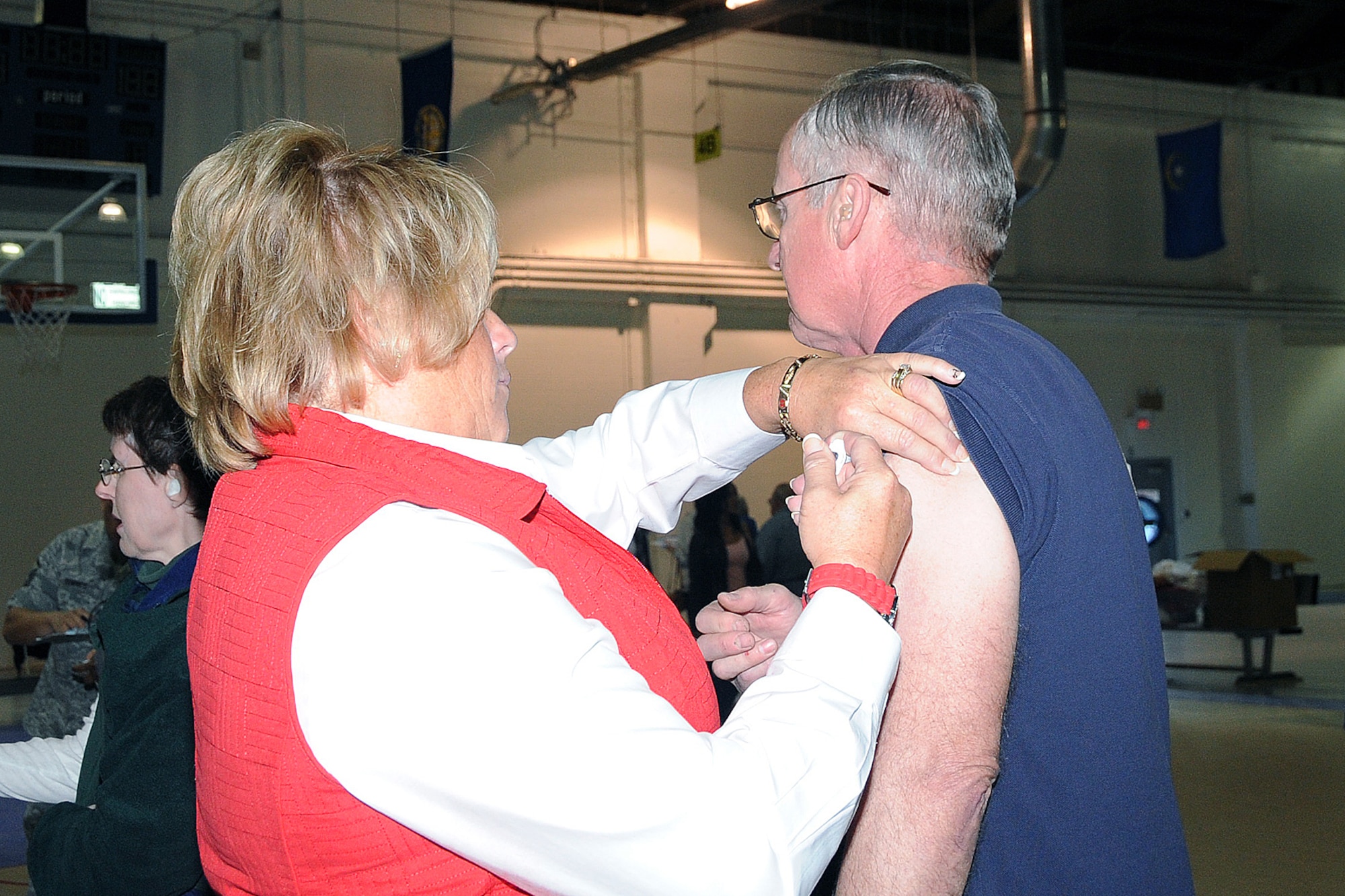 OFFUTT AIR FORCE BASE, Neb. - Robbin Alex, a registered nurse with the 55th Medical Group, administers a flu shot to Ron Pape, a retired U.S. Army Staff Sgt. during Offutt's annual Retiree Appreciation Day Oct. 17. This annual event was held at the Offutt Field House and gave retirees from the local area the opportunity to attend briefing and get information from a variety of agencies including the Retiree Activities Office, Airman & Family Readiness Center, Department of Veteran Affairs, Survivor Benefits, the Erhling Bergquist medical clinic, Legal Office and Dental Services in addition to immunizations. U.S. Air Force photo by Kendra Williams