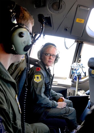Heidi Tingelhoff listens intently as Capt. Justin Jarrell answers questions and explains some of the functions in the aircraft?s cockpit, Oct. 16 during a spouses orientation flight. Mrs. Tingelhoff joined more than 60 other spouses, learning about their spouses? jobs during a local training mission. Mrs. Tingelhoff is the wife of Chief Master Sgt. Rudy Tingelhoff, 437th Operations Group and Captain Jarrell is a pilot with the 17th Airlift Squadron. (U.S. Navy photo/Mass Communication Specialist 1st Class Jennifer Hudson)