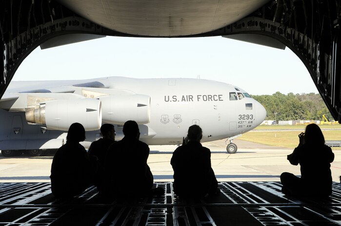 Spouses watch as a C-17 aircraft taxi?s after landing on Joint Base Charleston-Air Base. More than 60 spouses were given the opportunity to take a spouse orientation flight to learn what their spouse?s job entailed during a routine training flight onboard a Charleston C-17, Oct. 16. (U.S. Navy photo/Mass Communication Specialist 1st Class Jennifer Hudson)