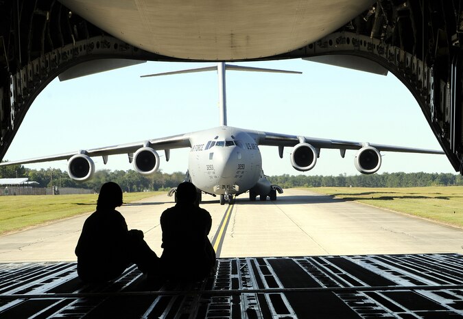 Spouses watch as a C-17 aircraft taxi?s after landing on Joint Base Charleston-Air Base. More than 60 spouses were given the opportunity to take a spouse orientation flight to learn what their spouse?s job entailed during a routine training flight onboard a Charleston C-17, Oct. 16. (U.S. Navy photo/Mass Communication Specialist 1st Class Jennifer Hudson)