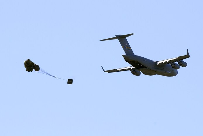 More than 60 spouses watched as two Charleston C-17 performed an airdrop training mission at North Field, Oct. 16. They conducted a heavy-air-drop and container delivery system-air-drop; dropping pallets and small containers from the cargo bay area of the plane. The wives were given the opportunity to take a flight from Joint Base Charleston-Air Base to the North training fields for routine training during a spouse orientation flight that helping to educate them on the airlift mission. (U.S. Navy photo/Mass Communication Specialist 1st Class Jennifer Hudson)