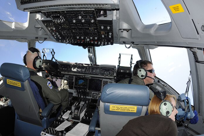 Chantil Stoddard, wife of 1st Lt. Eric Stoddard, looks out the C-17?s window during a spouse orientation flight, Oct 16.  The event was held to familiarize military spouses with their Airman?s job and showcase the unit?s mission. Mrs. Stoddard is the wife of 1st Lt. Eric Stoddard, a pilot with the 15th Airlift Squadron. (U.S. Navy photo/Mass Communication Specialist 1st Class Jennifer Hudson)
