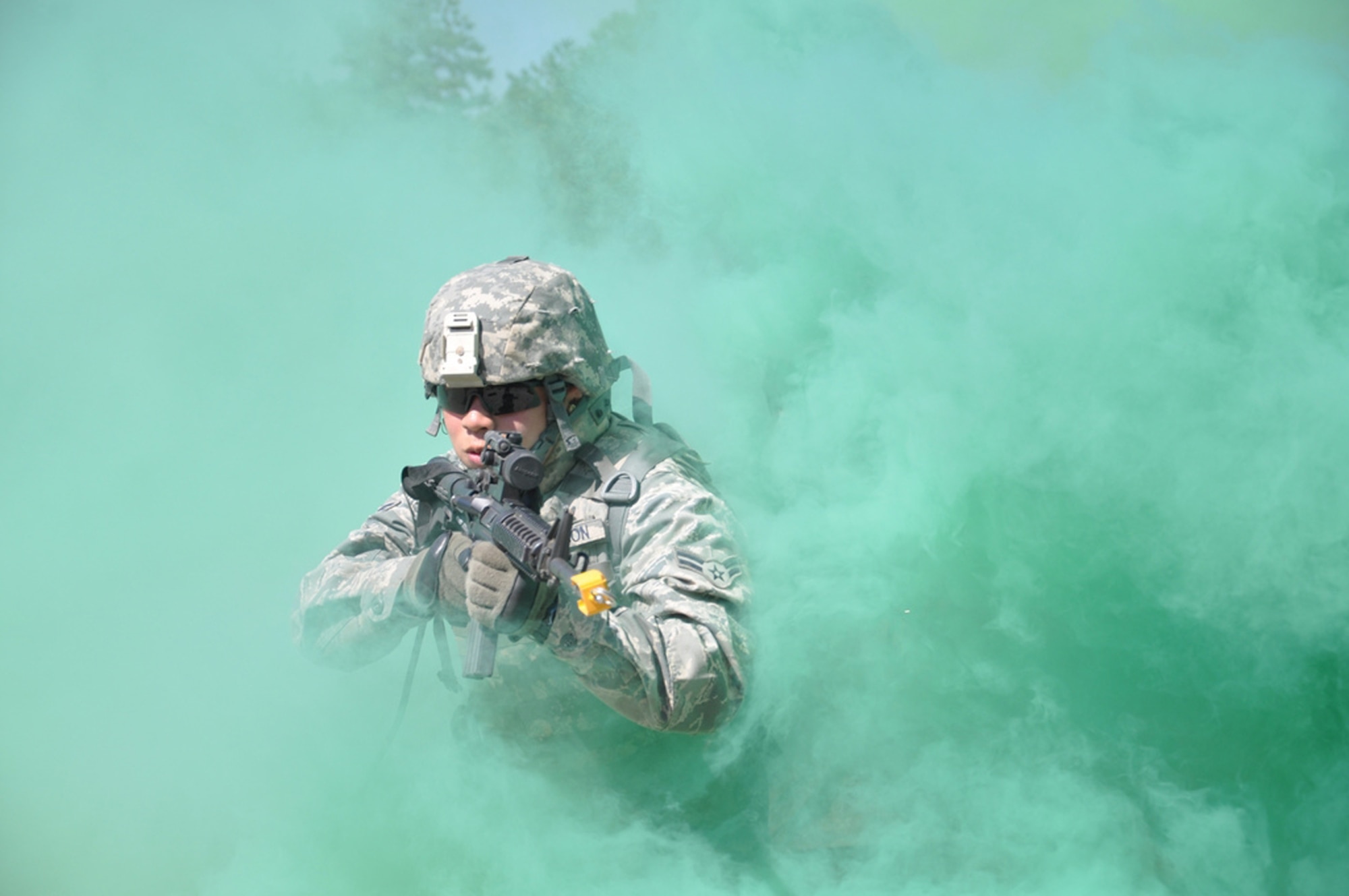 Airman 1st Class John Fallesgon peers through the smoke to engage enemy during a foot patrol at combat-skills training Sept. 2, 2010 at Joint Base McGuire-Dix-Lakehurst, N.J. Airman Fallesgon is a food services chef at Langley Air Force Base, Va. (U.S. Air Force photo/Chief Master Sgt. David Richards)