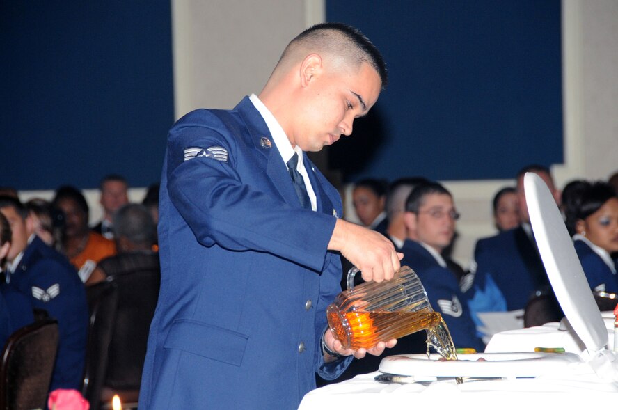OFFUTT AIR FORCE BASE, Neb. -  Staff Sgt. Dudley Lykins, 55th Aerospace Medicine Squadron and Sergeant at Arms for Offutt's annual Enlisted Dining Out, christens the Grog Bowl to kick off the event at the Patriot Club Oct. 15. The primary purpose of a dining-out is to bring military members together in an atmosphere of camaraderie, fellowship and social rapport. The goal is to have a good time and enjoy the company of fellow Airmen. U.S. Air Force photo by Kendra Williams