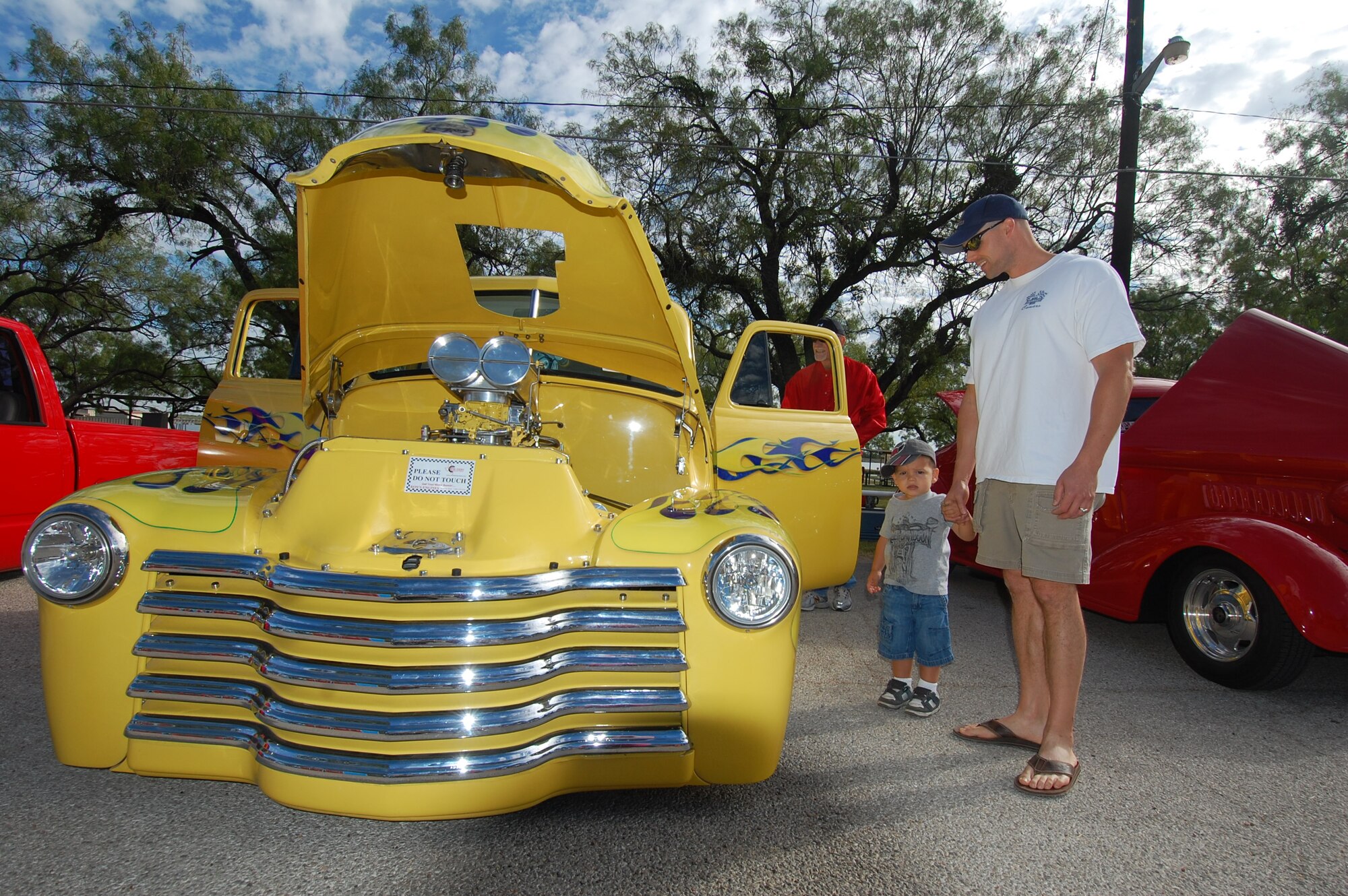 GOODFELLOW AIR FORCE BASE, Texas - Maj. Garrett Truskett, 17th
Contracting Squadron Commander, and his son Gunnar, 2, check out the hotrods at
Goodfellow's Recreation Camp Oct. 16. The base hosted a car show for anyone
who wanted to come and show off their vehicle. The show was open to the
public and included motorcycles, boats and cars of all types. (U.S. Air
Force photo/ Staff Sgt. Heather L Rodgers)